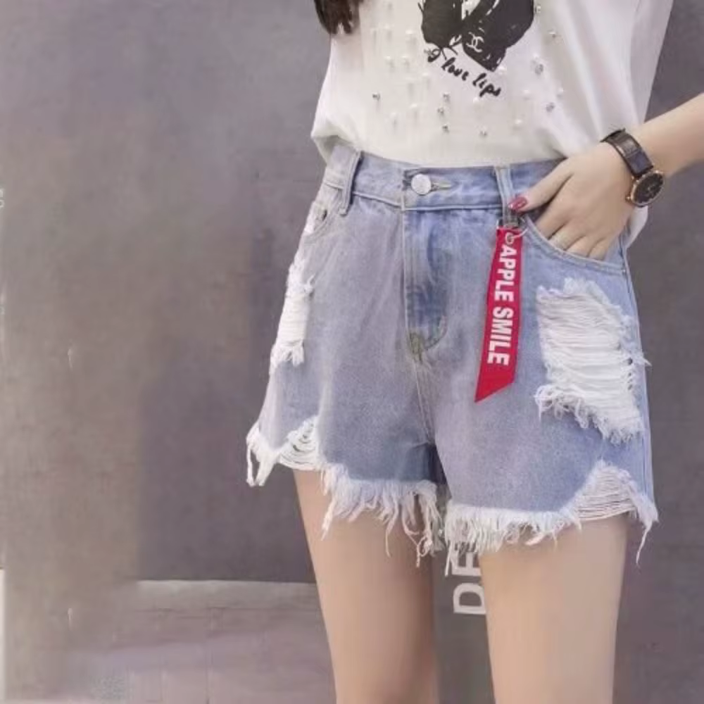 Shorts en jean tendance déchirés taille haute, polyvalents, avec ourlet effiloché et franges, 2024